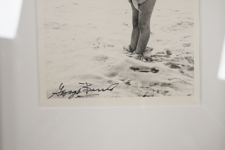 George Barris, a black and white photograph of Marilyn Monroe on a beach, signed in black ink by Barris to the lower edge of the image, stamped to the reverse ‘The Private Collection of Kim Goodwin’, 18 x 12.5cm